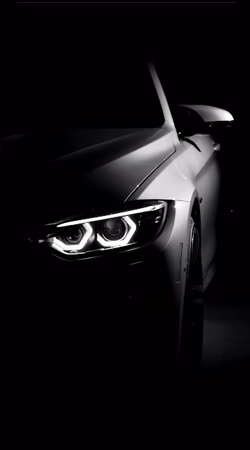 White Sports Car Headlight in Dark Studio Setting - Free 4K & 8K Mobile Wallpaper