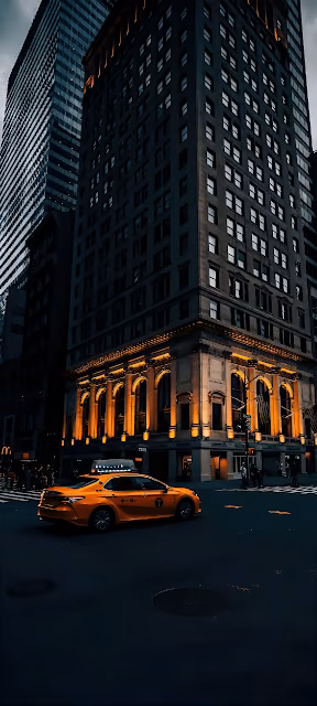 Yellow Taxi Passing Historic Building at Twilight - Free 4K & 8K Mobile Wallpaper